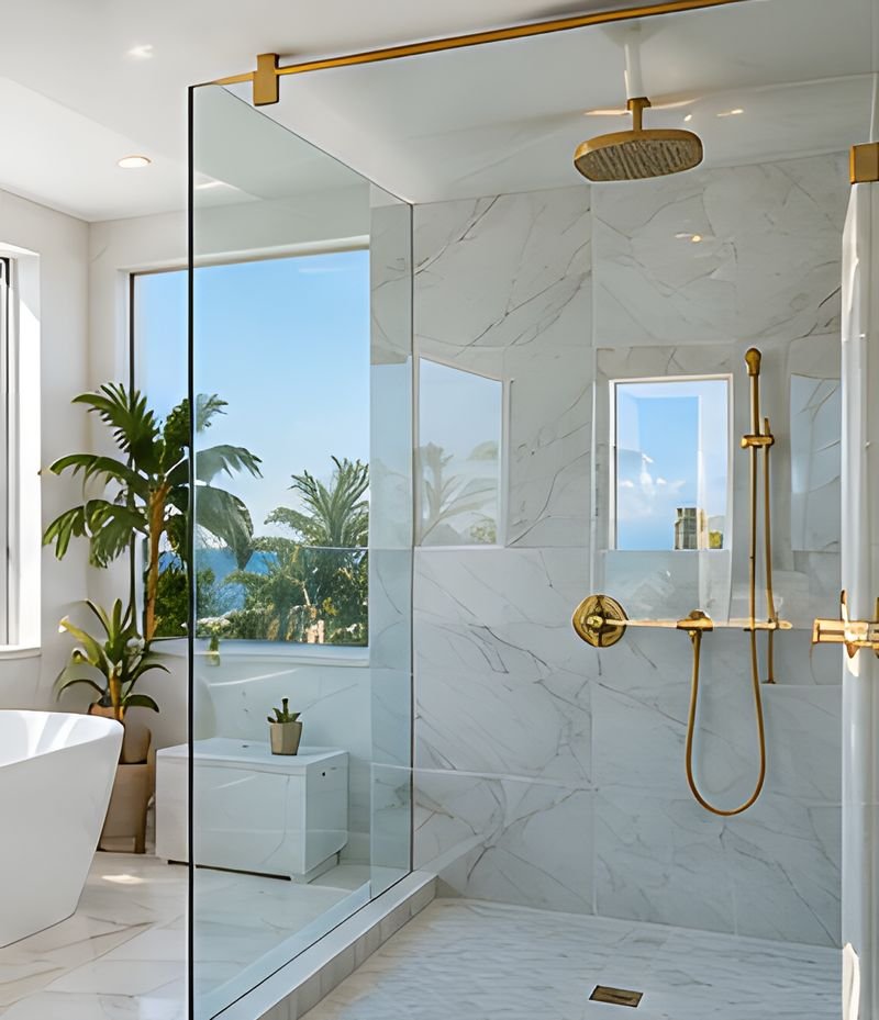 Bright bathroom with a glass-enclosed shower and a window with a view