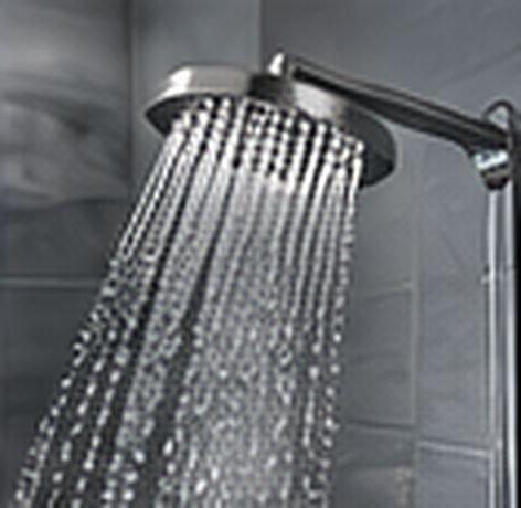 Close view of a rain shower head with running water